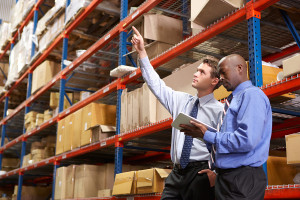 Two Businessmen With Digital Tablet In Warehouse